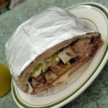 El Chevere Cuchifrito - This Cuban sandwich is not only tasty but enormous. This is only half. Great leftovers for dinner tonight - Dominican Near Me - New York, New York