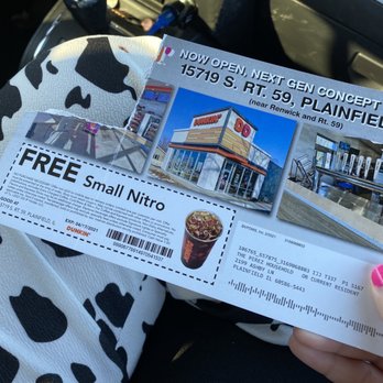 Dunkin' -  a woman holding a ticket for a dunkin donuts - Donuts Near Me - Plainfield, Illinois