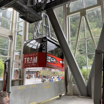 Goldbelt Tram - a man sitting in a chair with a view of a mountain - Hiking Near Me - Juneau, Alaska Goldbelt Tram - a man sitting in a chair with a view of a mountain - Hiking Near Me - Juneau, Alaska