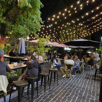 Paris Baguette - Patio area. Many lovely flowers on the perimeter. - Bakeries Near Me - Brea, California