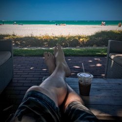 Sunset Beach Resort - Beautiful views from a tree canopy covered patio.
