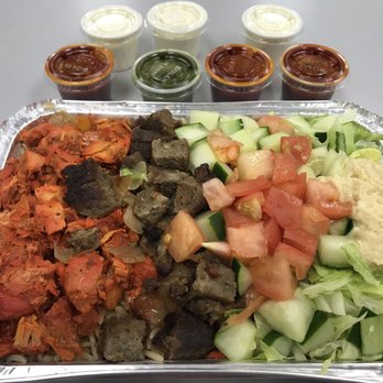 Shah's Halal Food - Combo platter over rice with sauces on the side. They are really generous with the sauce!! - Halal Near Me - East Meadow, New York