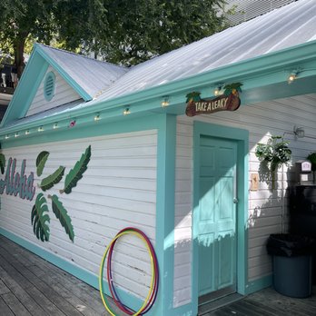 Placeholder - a white building with a blue door and a hula hoop - Tiki Bars Near Me - Austin, Texas Placeholder - a white building with a blue door and a hula hoop - Tiki Bars Near Me - Austin, Texas