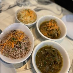 Irie Ting Jamaican Grill - Family style. Curry Chicken and Curry Goat with Rice & Peas and Cabbage.