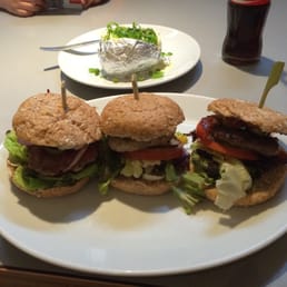 Trio of burger meister, chicken burger and Spanish burger... And a baked potato in the back ground Trio of burger meister, chicken burger and Spanish burger... And a baked potato in the back ground