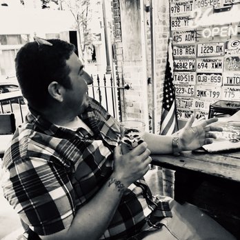 Lucky Lou's - a man sitting at a table in front of a wall of license plates - Bars Near Me - Little Rock, Arkansas Lucky Lou's - a man sitting at a table in front of a wall of license plates - Bars Near Me - Little Rock, Arkansas
