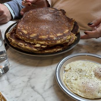 Uncle Wolfie's Breakfast Tavern - Johnny Cakes (3). These are huge. Side of over easy eggs. - Breakfast & Brunch Near Me - Milwaukee, Wisconsin Uncle Wolfie's Breakfast Tavern - Johnny Cakes (3). These are huge. Side of over easy eggs. - Breakfast & Brunch Near Me - Milwaukee, Wisconsin