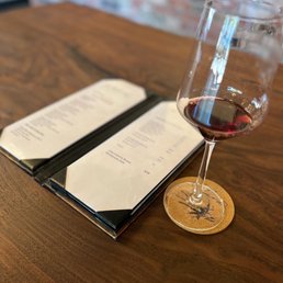 a glass of wine and menu