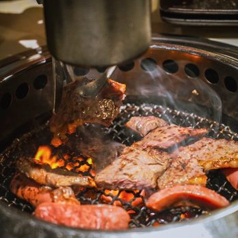 Shokunin BBQ - a person cooking meat on a grill - Japanese Near Me - Brooklyn, New York Shokunin BBQ - a person cooking meat on a grill - Japanese Near Me - Brooklyn, New York