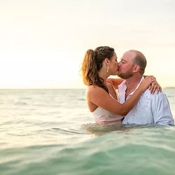 Sandhill Photography - Beer Can Island engagement photography, couple kissing in the water on Longboat Key