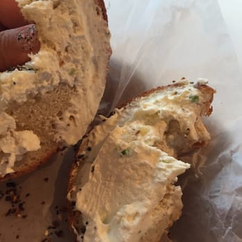 Wholy Bagel - 2 inches of cream cheese on one side. Sad face - Bagels Near Me - Austin, Texas
