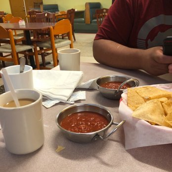 Los Enchilado’s - a man sitting at a table with a plate of nachos and a cup of coffee - Mexican Near Me - Kilgore, Texas Los Enchilado’s - a man sitting at a table with a plate of nachos and a cup of coffee - Mexican Near Me - Kilgore, Texas