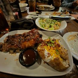 Baby back ribs , fully loaded bake potatoe and a house salad with a peach tea. Baby back ribs , fully loaded bake potatoe and a house salad with a peach tea.