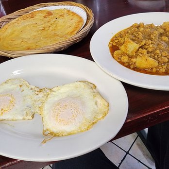 Dera Restaurant - The brunch spread: fried eggs, chicken keema aloo, and the beautifully golden fried paratha - Indian Near Me - Jackson Heights, New York Dera Restaurant - The brunch spread: fried eggs, chicken keema aloo, and the beautifully golden fried paratha - Indian Near Me - Jackson Heights, New York