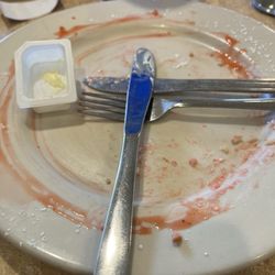 Lux Cafe - The remnants of a massacred 3 stack of pancakes with strawberry syrup and whipped cream.