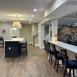 Who can remodel my basement in the Frederick, MD area with quality results. This renovation features a home gym, movie room, and wet bar.