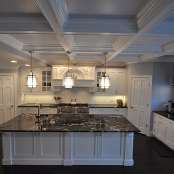 Homecraft Remodeling - a kitchen with white cabinets and black countertops - General Contractors Near Me - Plainview, New York Homecraft Remodeling - a kitchen with white cabinets and black countertops - General Contractors Near Me - Plainview, New York
