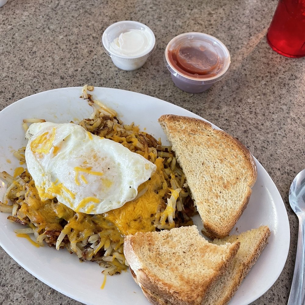 Village Diner - Southwest stuffed hash browns with 2 over easy eggs and sourdough toast. - American Near Me - Fruitport, Michigan Village Diner - Southwest stuffed hash browns with 2 over easy eggs and sourdough toast. - American Near Me - Fruitport, Michigan