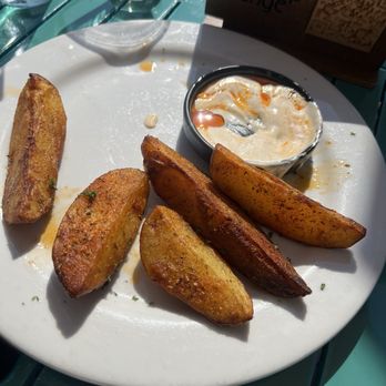 The Rooftop Lounge - Seasoned potato wedges with some sort of tahini sauce with drizzled chili oil. Nicely done! - Lounges Near Me - Laguna Beach, California The Rooftop Lounge - Seasoned potato wedges with some sort of tahini sauce with drizzled chili oil. Nicely done! - Lounges Near Me - Laguna Beach, California