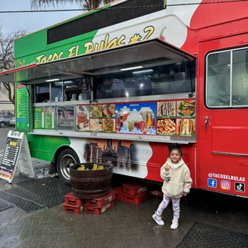 Tacos el Rulas - a little girl standing in front of a food truck - Tacos Near Me - Richmond, California Tacos el Rulas - a little girl standing in front of a food truck - Tacos Near Me - Richmond, California