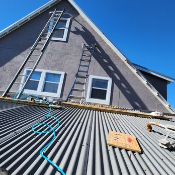 Buckholts Construction - a ladder on the roof of a house - General Contractors Near Me - Caldwell, Texas