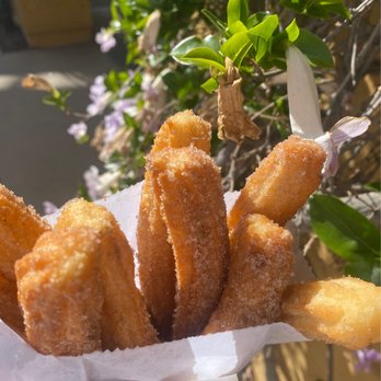 Churros el Tigre - a person holding a basket of churros - Food Stands Near Me - San Diego, California Churros el Tigre - a person holding a basket of churros - Food Stands Near Me - San Diego, California