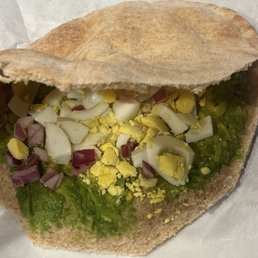 Wheat pita bread with avocado, boiled egg and red onions. (Egg sandwich is what they considered it)