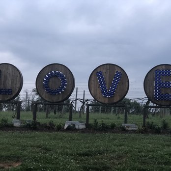 Prince Michel - This display of blue wine bottles in oak barrel tops spelling out LOVE in front of the winery. - Wine Tasting Room Near Me - Leon, Virginia Prince Michel - This display of blue wine bottles in oak barrel tops spelling out LOVE in front of the winery. - Wine Tasting Room Near Me - Leon, Virginia