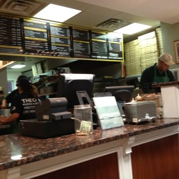 Theo's Pizzeria & Grill - a woman working behind the counter - Pizza Near Me - Weston, Massachusetts