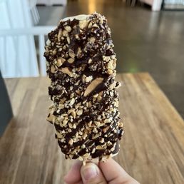 Vanilla PopGelato with dark chocolate, waffle cone and toffee, and carmel dark chocolate drizzle Vanilla PopGelato with dark chocolate, waffle cone and toffee, and carmel dark chocolate drizzle