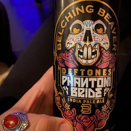 a person holding a can of beer