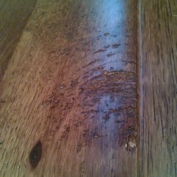 Area about the size of an open hand where stain and finish missing Area about the size of an open hand where stain and finish missing