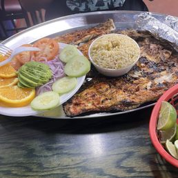 grilled fish with side of rice and side of salad