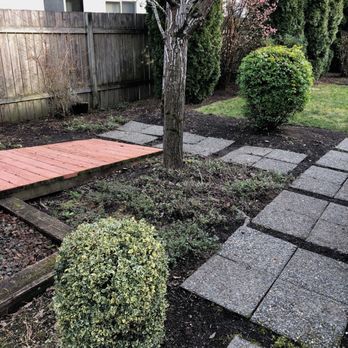 Hernandez Landscape - a garden with a tree and a brick walkway - Landscaping Near Me Hernandez Landscape - a garden with a tree and a brick walkway - Landscaping Near Me