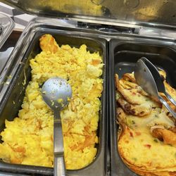 Holiday Inn Express & Suites Martinsville-Bloomington Area - Notice the brown burnt edges on eggs.  Bits of brown stuff in the scramble eggs.  Notice the dark brown biscuits they were hard as a rock.