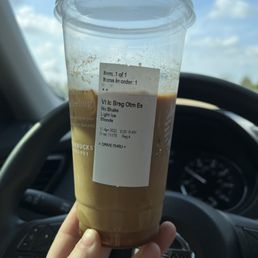 a hand holding a cup of coffee a hand holding a cup of coffee