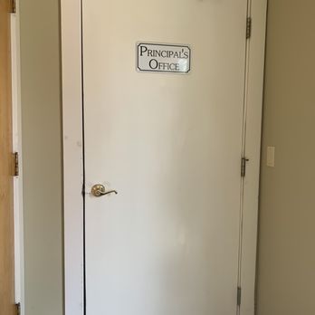 Peninsula Cellars - a white door with a sign on it - Wine Tasting Room Near Me - Traverse City, Michigan