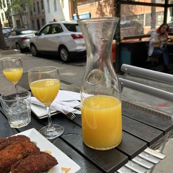 The Stag's Head - a table with a pitcher of orange juice and two glasses of orange juice - New American Near Me - New York, New York The Stag's Head - a table with a pitcher of orange juice and two glasses of orange juice - New American Near Me - New York, New York