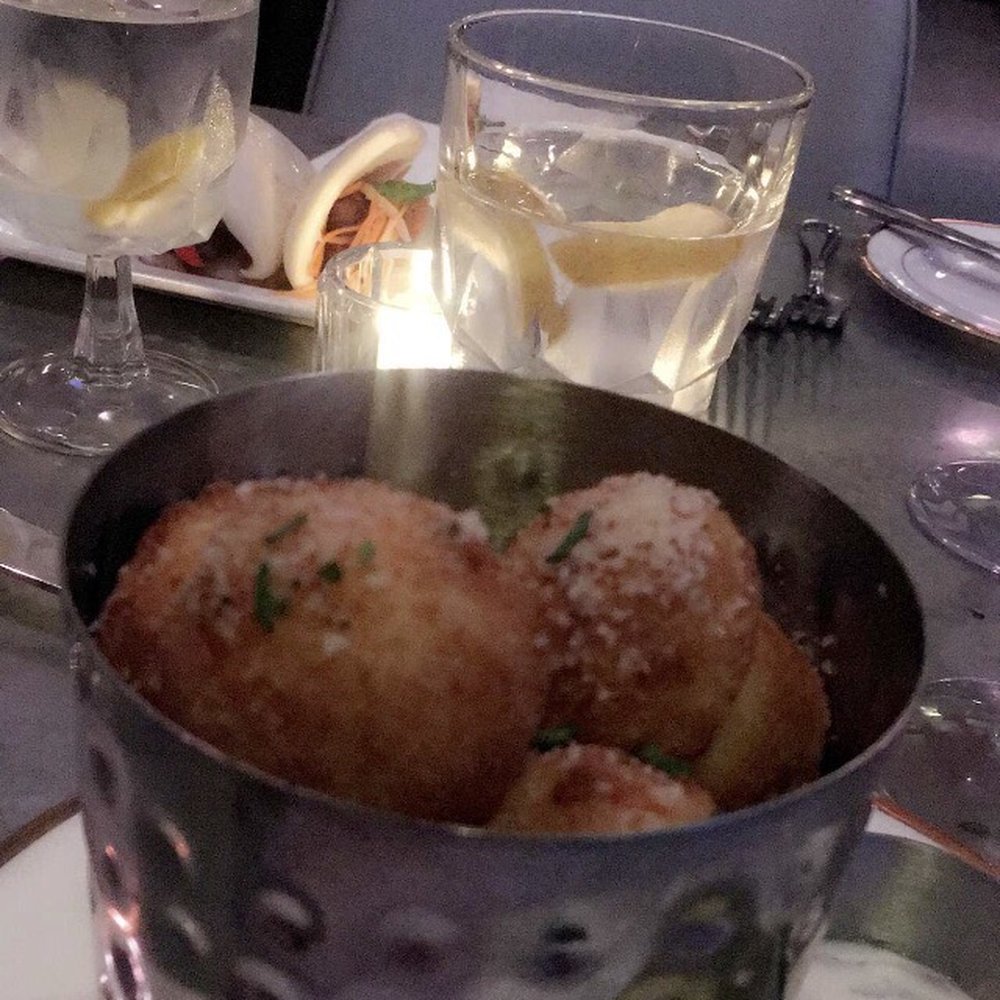 The West End - Truffle tots with steam buns in the background. - New American Near Me - Hyannis, Massachusetts The West End - Truffle tots with steam buns in the background. - New American Near Me - Hyannis, Massachusetts