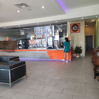 Teapioca Lounge - a woman standing in front of a counter - Coffee & Tea Near Me - Kyle, Texas