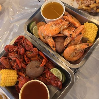 Crawfish Chef - Crawfish with house sauce in the side + Shrimps with head on with lemon butter sauce on the side and crab fries in the back - Seafood Near Me - Seattle, Washington
