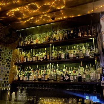 Finn's Manor - a bar with a lot of bottles on the shelves - Cocktail Bars Near Me - Denver, Colorado