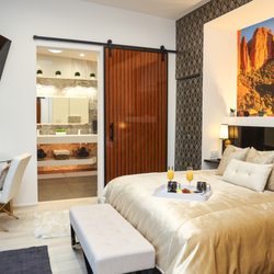 Sedona Penthouse - King bed with built in granite headboard. Custom mural of Sedona, large rosewood barn doors for privacy with on suite 350 sqft spa bathroom.