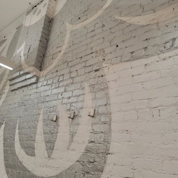 Frita Batidos - Great graphics on the bright white brick walls. - Cuban Near Me - Ann Arbor, Michigan