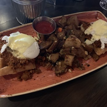 Copper Blues Rock Pub & Kitchen - Eggs benny on a waffle with chorizo and house potatoes - Bars Near Me - Doral, Florida