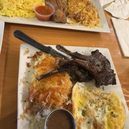 Lamb chops, fried catfish, eggs fried hard with the yolks broken with house made sauces Lamb chops, fried catfish, eggs fried hard with the yolks broken with house made sauces