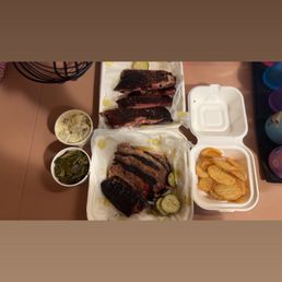 Pork ribs, beef brisket, tallow fries, potato salad and collard greens Pork ribs, beef brisket, tallow fries, potato salad and collard greens