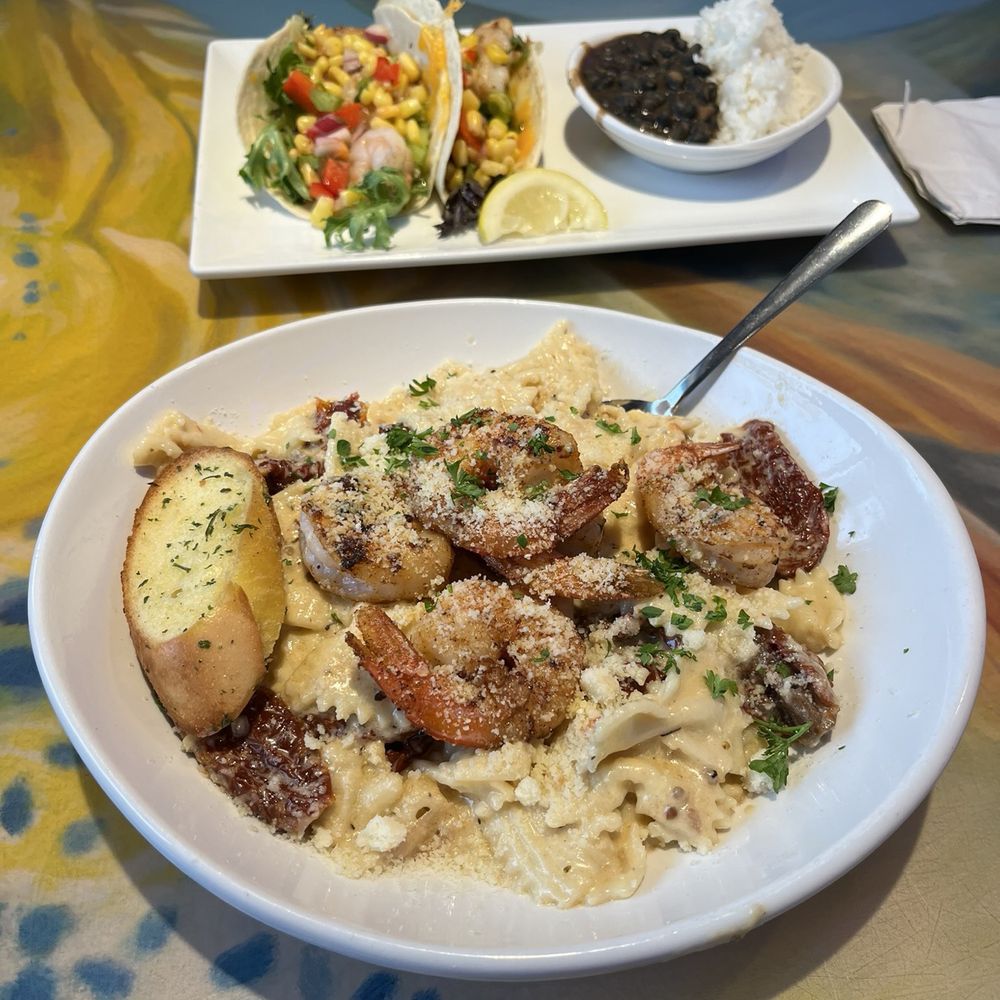 Coconuts On The Beach - Sundried tomato pasta with shrimp (bottom) Reef Tacos* shrimp (top) - Bars Near Me - Cocoa Beach, Florida Coconuts On The Beach - Sundried tomato pasta with shrimp (bottom) Reef Tacos* shrimp (top) - Bars Near Me - Cocoa Beach, Florida