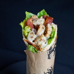 Pita Pit - Grilled chicken, crisp romaine, parmesan, and creamy Caesar dressing wrapped in pita--a classic with a twist.