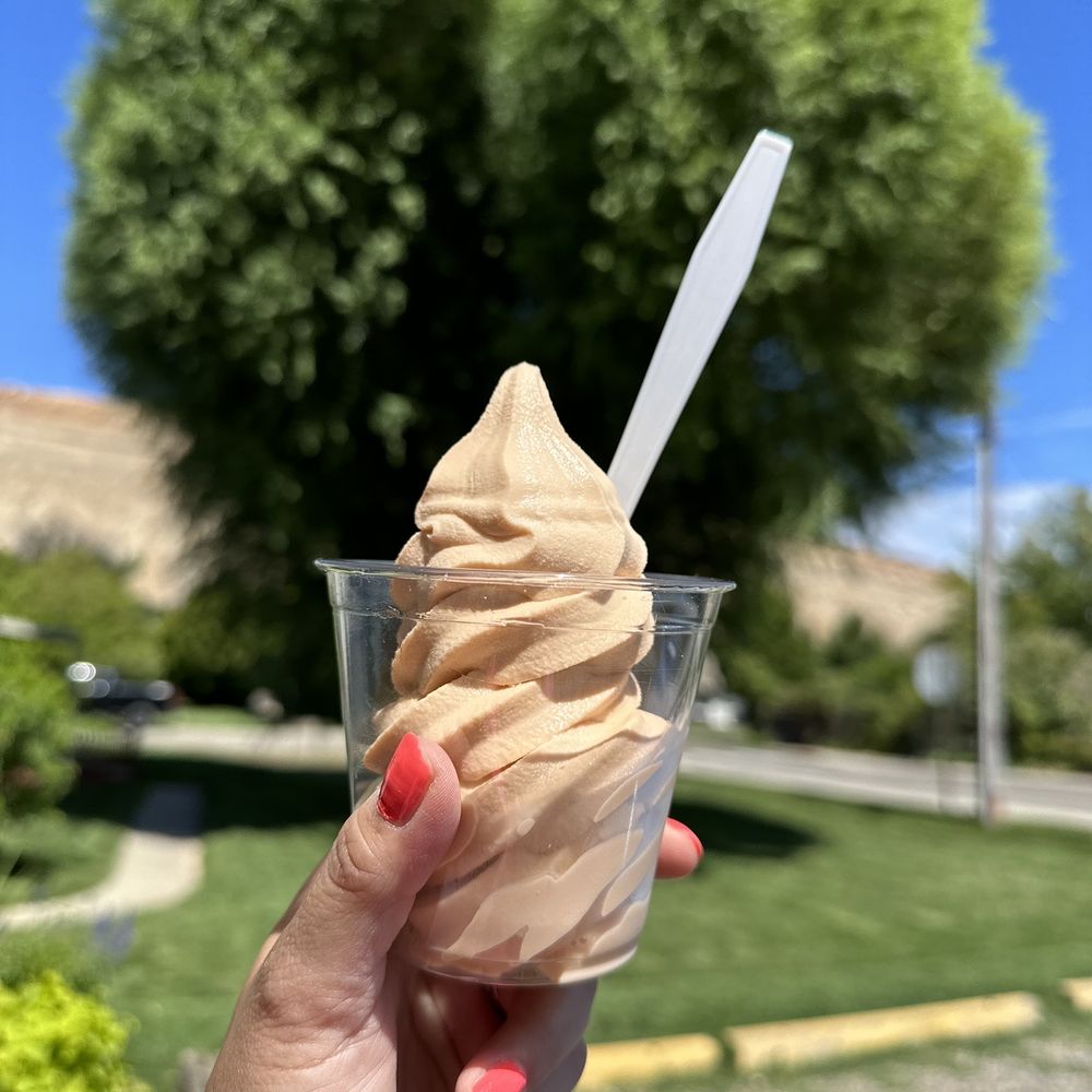 a hand holding a cup of ice cream a hand holding a cup of ice cream